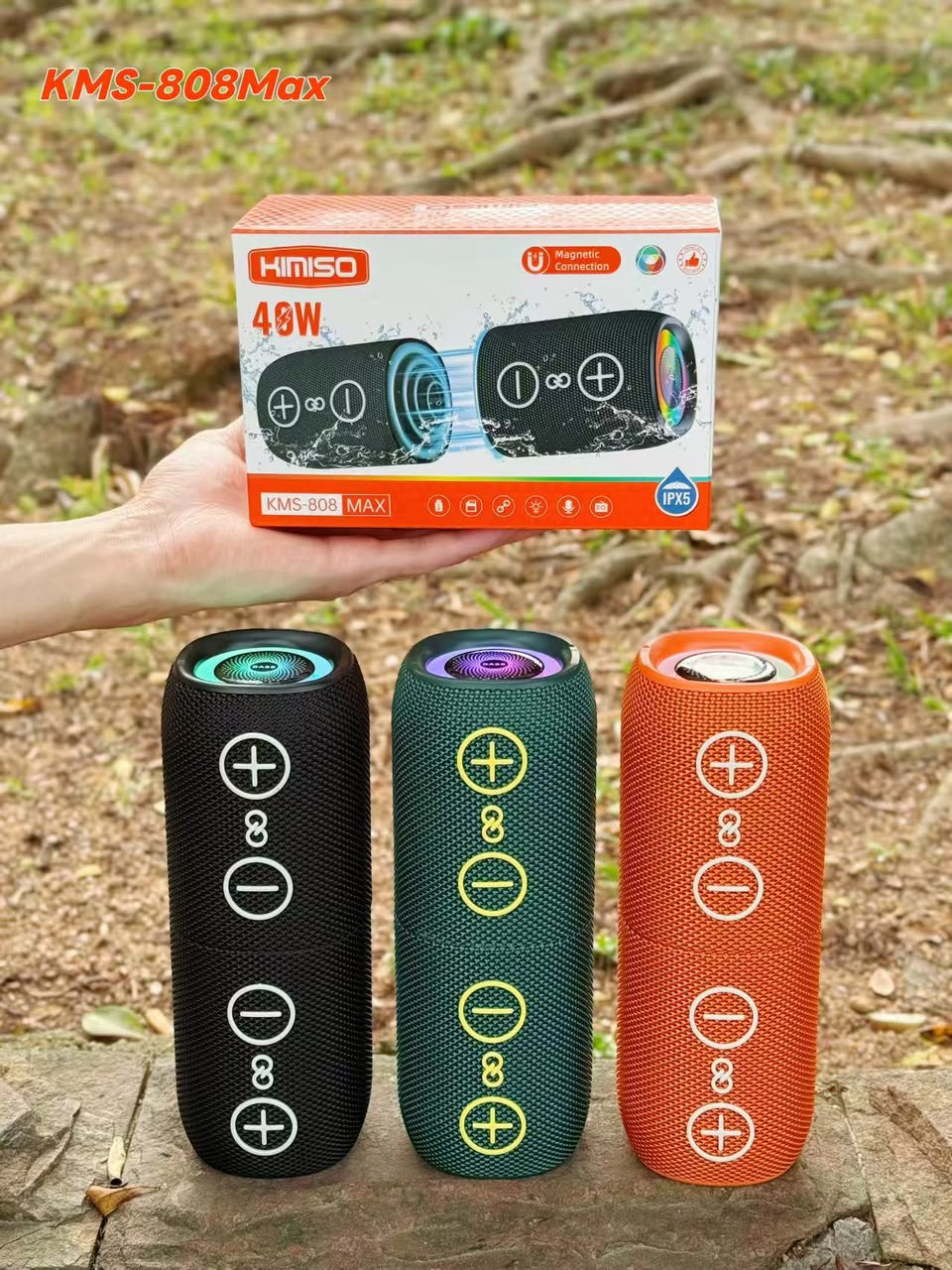 KMS-808MAX held in hand showing carry strap and USB/charging port