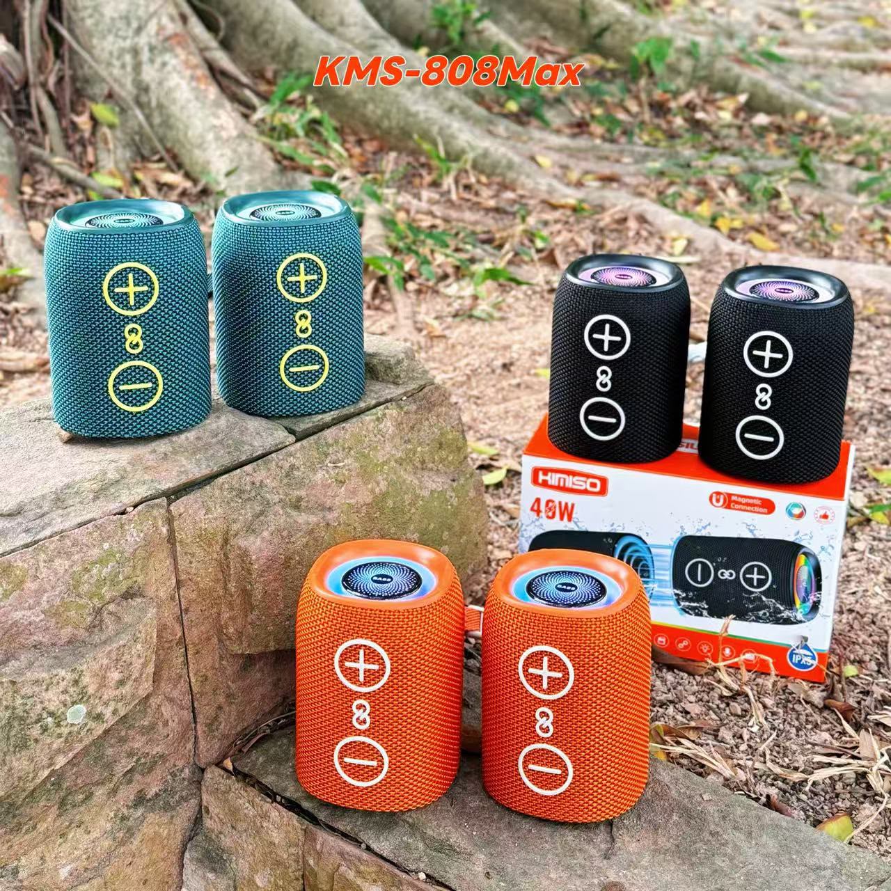 Four KMS-808MAX speakers split apart in teal, black, and orange showing the RGB light ring